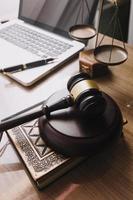 Business and lawyers discussing contract papers with brass scale on desk in office. Law, legal services, advice, justice and law concept picture with film grain effect photo