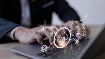man use Laptop with cloud computing diagram show on hand. Cloud technology. Data storage. Networking and internet service concept. photo