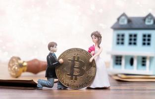 Doll Groom propose marriage to bride with future BTC bitcoin cryptocurrency wealth investment. Virtual money coin exchange trade around World payment. Romance moment for bridal valentine. copy space photo