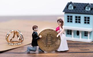 Doll Groom propose marriage to bride with future BTC bitcoin cryptocurrency wealth investment. Virtual money coin exchange trade around World payment. Romance moment for bridal valentine. copy space photo