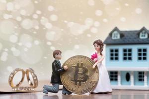 Doll Groom propose marriage to bride with future BTC bitcoin cryptocurrency wealth investment. Virtual money coin exchange trade around World payment. Romance moment for bridal valentine. copy space photo