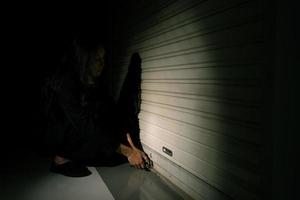 Woman depressed from sad stress pain despair problem, person try to open lock shop alone with emotion lonely desperate upset head down. Head in hand no way out concept, copy space photo