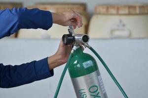 man open oxygen cylinder photo