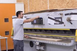 worker in a factory of wooden furniture photo