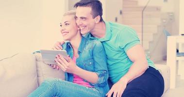 couple relaxing at  home with tablet computers photo