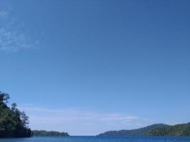 Tropical island with blue sea and blue sky photo