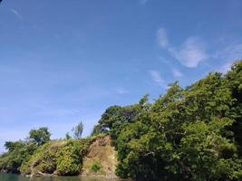 a tropical island with blue sky photo