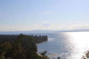 view of open sea with tropical island under the blue sky photo