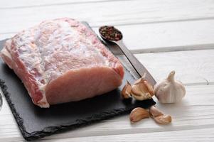 A large piece of pork loin on a rustic white background. photo