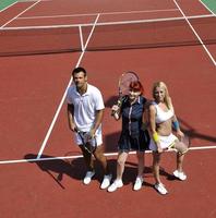 happy young couple play tennis game outdoor photo