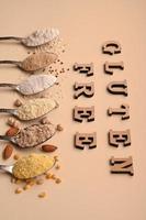 Gluten free text and spoons of various gluten free flour. Flat lay, top. photo