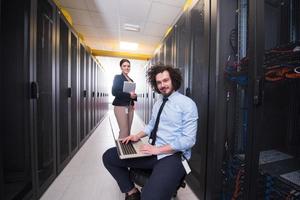 Team of young technicians working together on servers photo