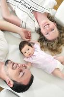 indoor portrait with happy young family and  cute little babby photo