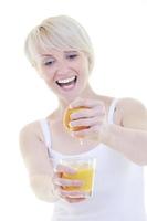 Young woman squeeze orange juice photo