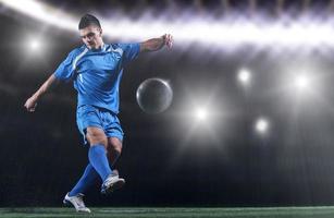 soccer player in front of big modern stadium with flares and lights photo