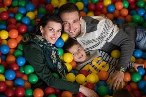 young parents with kids in a children's playroom photo