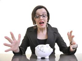 business woman putting money coins in piggy bank photo