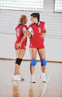 girls playing volleyball indoor game photo