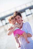 mom and baby on beach  have fun photo