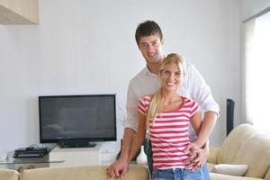 Relaxed young  couple watching tv at home photo