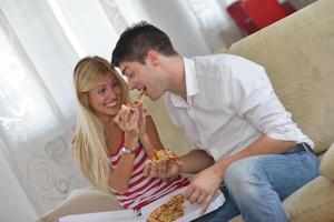 couple at home eating  pizza photo