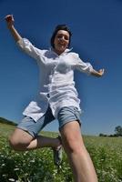 Young happy woman in green field photo