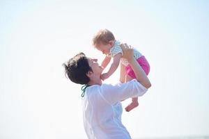 mom and baby on beach  have fun photo