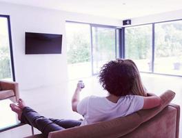 Rear view of couple watching television photo