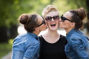 portrait of three young beautiful woman with sunglasses photo