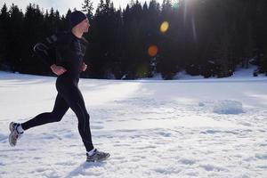 jogging on snow in forest photo