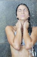 sexy young woman enjoing bath under water shower photo