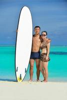 happy young  couple enjoying summer on beach photo