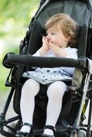 baby girl sitting in the pram photo