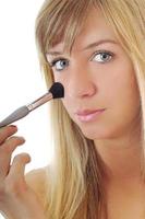 Woman applying makeup photo