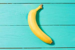 Macro Fruits. Banana on blue wooden table background. Summer time. Selective focus photo