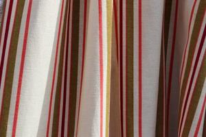 Detailed close up view on samples of cloth and fabrics in different colors found at a fabrics market photo