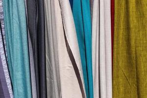 Detailed close up view on samples of cloth and fabrics in different colors found at a fabrics market photo