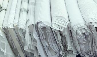 Detailed close up view on samples of cloth and fabrics in different colors found at a fabrics market photo
