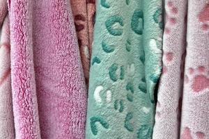 Detailed close up view on samples of cloth and fabrics in different colors found at a fabrics market photo