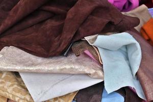 Detailed close up view on samples of cloth and fabrics in different colors found at a fabrics market photo