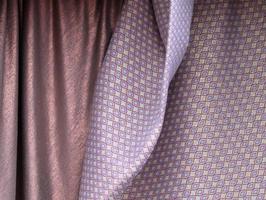 Detailed close up view on samples of cloth and fabrics in different colors found at a fabrics market photo