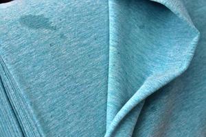 Detailed close up view on samples of cloth and fabrics in different colors found at a fabrics market photo