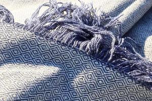 Detailed close up view on samples of cloth and fabrics in different colors found at a fabrics market photo