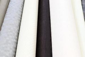 Detailed close up view on samples of cloth and fabrics in different colors found at a fabrics market photo