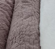 Detailed close up view on samples of cloth and fabrics in different colors found at a fabrics market photo