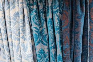 Detailed close up view on samples of cloth and fabrics in different colors found at a fabrics market photo