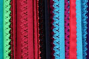 Detailed close up view on samples of cloth and fabrics in different colors found at a fabrics market photo