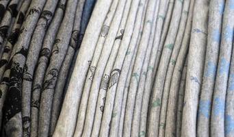 Detailed close up view on samples of cloth and fabrics in different colors found at a fabrics market photo