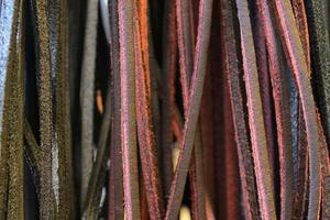 Detailed close up view on samples of cloth and fabrics in different colors found at a fabrics market photo