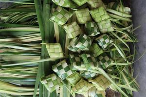 Ketupat or Rice Dumplings. Ketupat is a natural rice sleeve made from young coconut leaves to cook rice which is always available during Islamic holidays photo